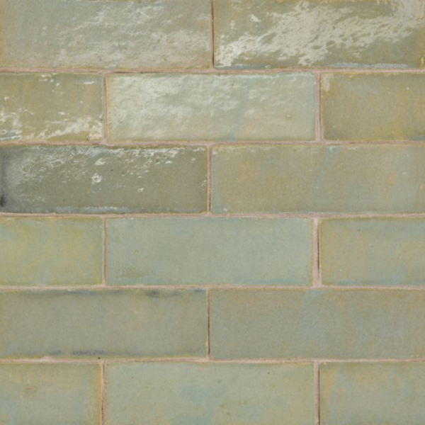 Close-up of colorful handmade Zellige tiles showcasing unique variations in color, texture, and glossy finish, highlighting Moroccan craftsmanship.